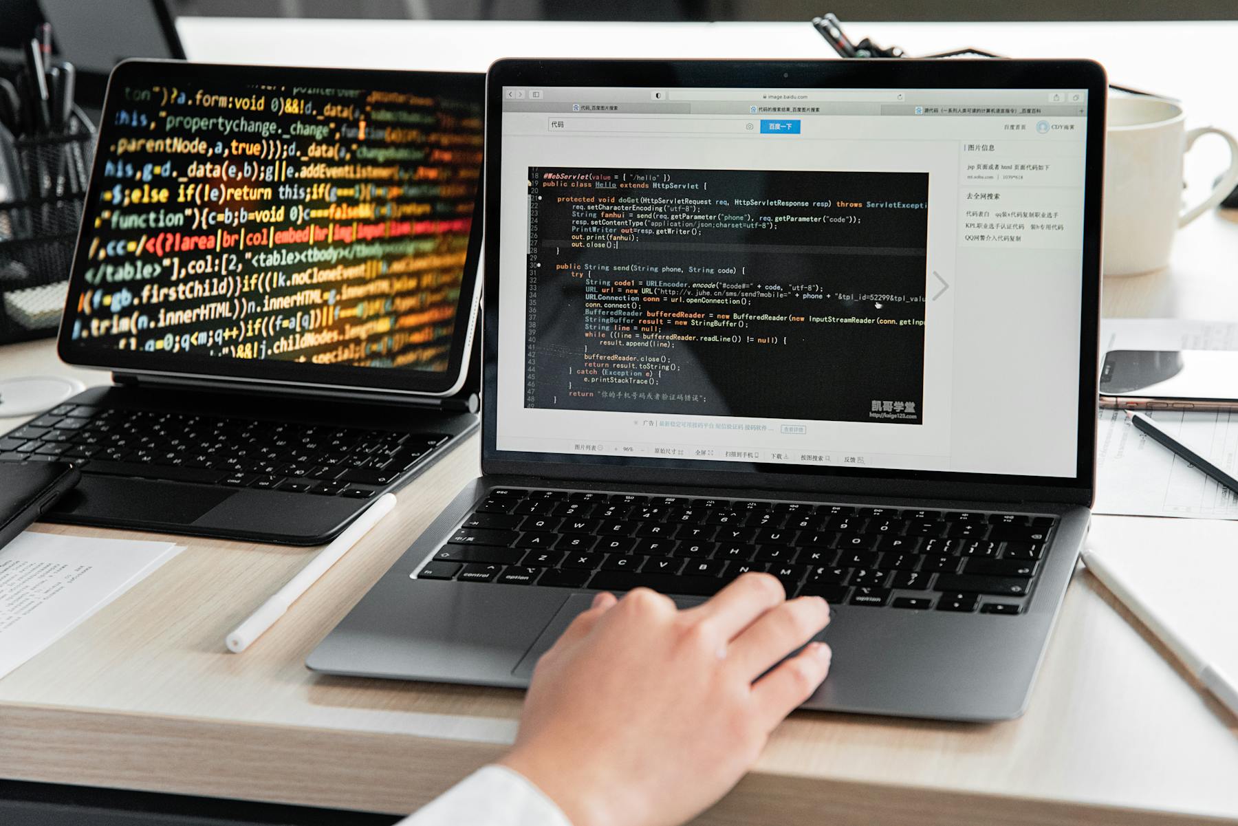 Developer working with code on a laptop in a modern office